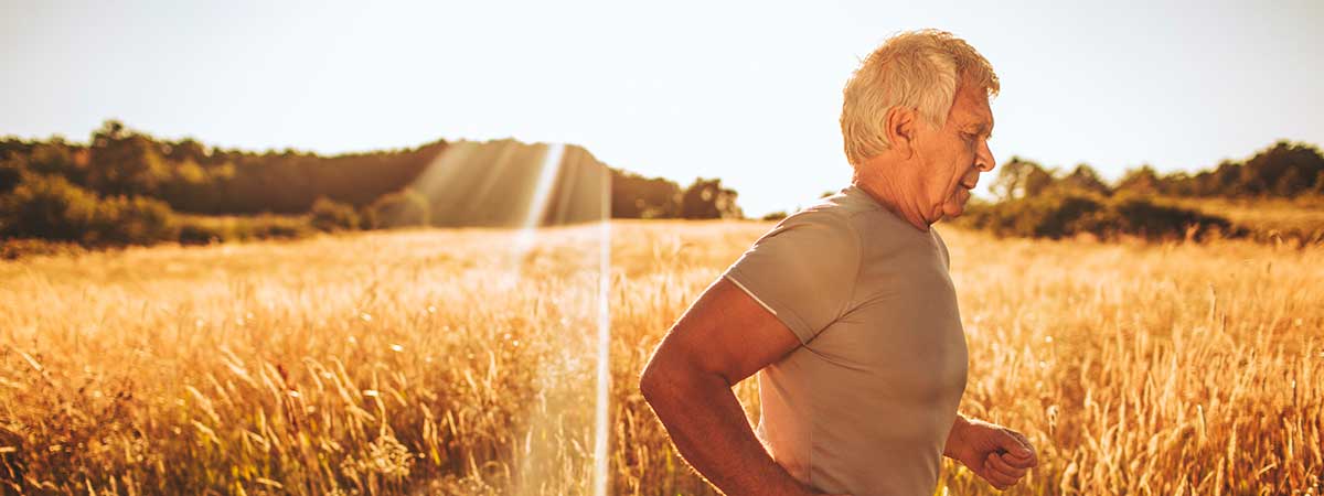 Man jogging by field
