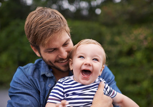 Father with infant after hearing treatment